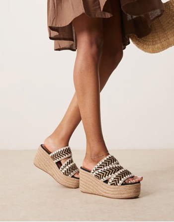 Thistle whipstitch detail wedge mules in natural and black