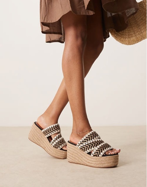 Thistle whipstitch detail wedge mules in natural and black